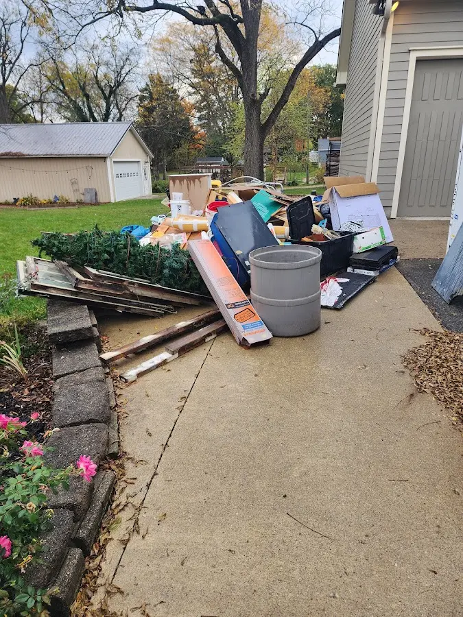 Dumpster being loaded with debris for 3 Yard Dumpster Rental in Oswego